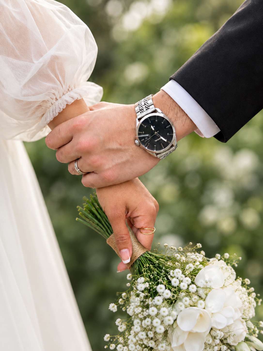 Ajay and Meenu holding hands with a white wedding bouquet